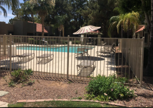 DCS Pool Barriers wrought iron pool fence secures apartment complex's pool area.