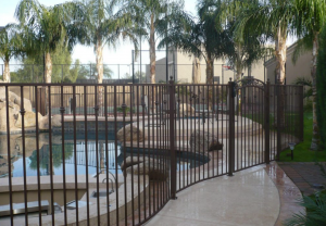 DCS Pool Barriers wrought iron pool fence secures a residential pool area.