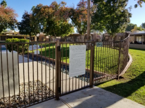 Wrought iron community pool fencing encloses a pool area at an HOA-governed neighborhood in Phoenix.